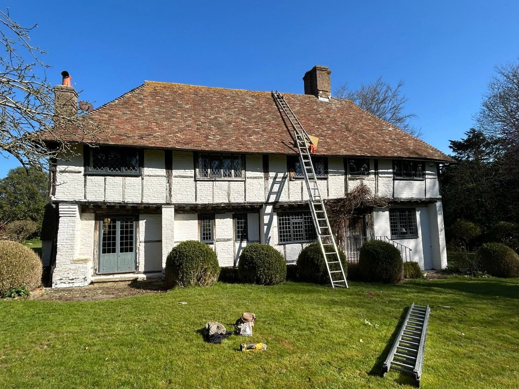 Grade II listed timber-framed house with a Kent peg tile roof being worked on by ADM Roofing Services